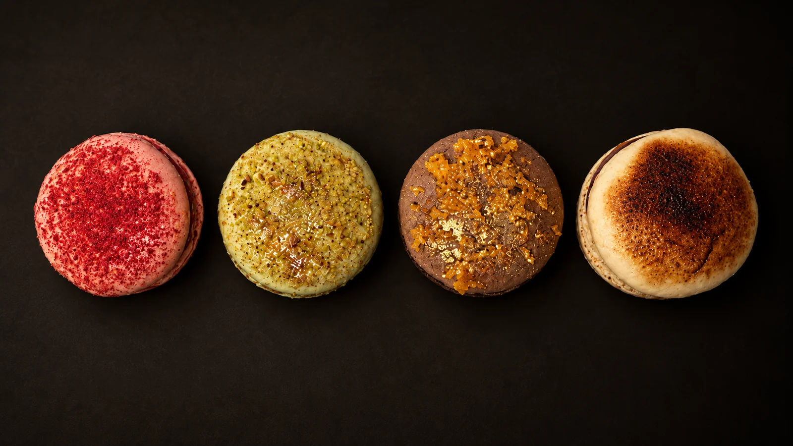 The four signature macarons: raspberry, pistachio, chocolate, caramel
